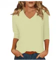 Close-up detail of the classic V-neckline and comfortable three-quarter sleeves on t-shirt - Beige