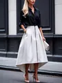 Full length side view of an elegant irregular hem white midi skirt with front zipper and pockets - S / Bottoms / White