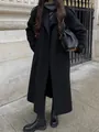 Detailed street style view of a black double-breasted long overcoat with chic boots - S / Tops / Black