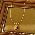 Goldene Vintage-Halskette mit Stern-Zirkon und ovalem Tigeraugen-Anhänger Design. - Halskette / Gold
