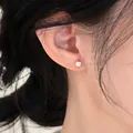 Macro view of a minimalist square silver stud earring worn elegantly on a female ear - Square (HE35956) / 925 Silver Earring Post / Silver