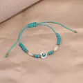 Handmade light blue beaded bracelet with white heart Evil Eye charm and adjustable cord - Style 77-Heart-shaped Evil Eye Woven Chain (Style 77)