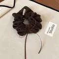 Detail view of a retro brown polka dot scrunchie with a delicate bow and handmade tag - Scrunchie (Coffee) / Coffee