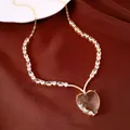 Close-up of gold-plated zircon necklace with a large clear heart-shaped crystal pendant - Gold-White