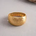 Detailed view of wide hammered gold metal bangle with irregular textured surface - Matte Finish / Gold