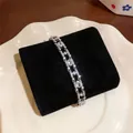 Close-up detail of 18k gold plated bracelet featuring sparkling oval cubic zirconia stones - Oval Geometric / Silver