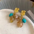Close-up of vintage Maillard style drop earrings with turquoise and amber leaf beads - Leaf Tassel Style (HE35918) / Gold-Blue-Brown