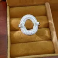 Detailed close-up of a shimmering silver-tone oval hollow ring pavé-set with clear zirconia - Round Hollow Pave Style / Silver