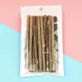 Natural wood chew sticks for cats in clear packaging on pink and blue studio background. - Silvervine Stick / 15 Pieces/Pack