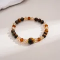 Macro view showing the natural texture of tiger eye stones and faceted amber beads - Gold Brown
