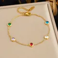 Eleganter vergoldeter Edelstahlarmreif mit farbigen Zirkoniasteinen in Zargenfassung - Armband
