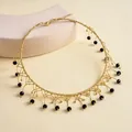 Detailansicht eines Vintage-Halsbandes aus Goldperlen mit schwarzen Glasperlenfransen. - Goldenes Halsband / Schwarz