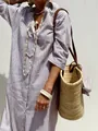 Detailed view of a tan and white striped shirt dress styled with a summer straw bag. - S / Dresses / Light Brown Striped