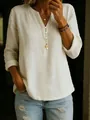 Detailed view of a woman wearing a cream cotton-linen V-neck long sleeve top with buttons - Off White