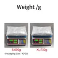 Detail showing the weight of sequin dress sizes S (690g) and XL (730g) on a scale. - S / Dresses / Silver Sequin (Size S 690g) / Silver