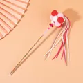 Close-up detail of fairy cat teaser wand with colorful pom-poms and long tassels - Red Pink White Balls With Rose Purple White Tassels