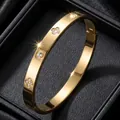 Luxury gold-plated stainless steel bangle with sparkling crystal flower and screw motifs - Clover Style (41-B-7)