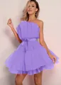 Elegant detail showing the texture of a purple tube top tulle party dress with a bow. - Purple