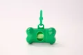 Durable green bone-shaped dog waste bag dispenser with clip for outdoor walking - Green