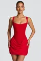Close-up of red sleeveless low-neck bodycon mini dress with draped skirt detail - Red