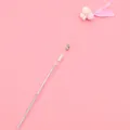 Long fairy cat teaser wand with pink feather, bells, and pom-poms for interactive play. - Clover Style / Pink