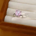 Close-up of pink cushion-cut zircon ring with clear stone accents in a jewelry box - Ring Only / Silver Pink