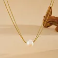 Macro view of natural freshwater pearl on a golden double layer snake chain necklace - Gold Double Layer Snake Chain Freshwater Pearl Necklace (D705)