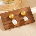 Detailed close-up view of elegant gold ball earrings with white baroque freshwater pearls. - Gold Freshwater Pearl Stud Earrings (G207)
