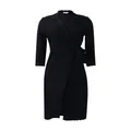 Detailed view of black suit-collar wrap dress with side tie and pleated hem. - S / Dresses / Black