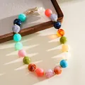 Detail view of colorful marbled acrylic beaded necklace with adjustable gold clasp - Necklace / Colorful