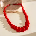 Close-up of red acrylic beaded necklace with geometric marble pattern and lobster clasp - Style 41 (Red)