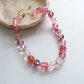 Detail of handmade acrylic necklace with pink swirled beads and gold clasp - Transparent Pink