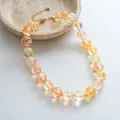 Elegant handmade acrylic marbled beaded necklace featuring adjustable golden chain closure - Transparent Yellow