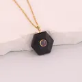Detailed view of a hexagonal black sandstone pendant featuring a sparkling inset stone - Black Goldstone Style (12#) / Obsidian