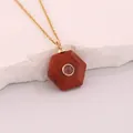 Close-up of a hexagonal red natural stone pendant necklace with central purple crystal - Pigeon Blood Red