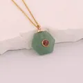 Close-up of hexagonal green natural stone pendant with garnet center on gold chain - Green Aventurine
