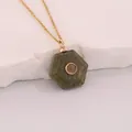 Macro detail of a hexagonal green natural stone pendant necklace with a gold-tone chain - Green System Style (7#) / Verdant