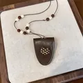 Close-up of brown PU leather cat pendant necklace with polka dot and bead details - Cat / Coffee