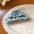 Close-up of a retro blue and green plaid acrylic bow hair claw clip on a white textured plate - Green Stripe Claw Clip