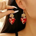 Elegant gothic heart drop earrings featuring red faceted crystal and gold rose detail. - Heart Gem Rose Earrings (10892) / KC Gold