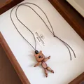 Detail view of a handmade wooden bear pendant necklace on a natural brown leather cord - Necklace-Coffee (Bear)