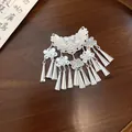 Detail view of a vintage ethnic style silver tassel hair clip on a dark wooden table - Duckbill Hair Clips / 1 Piece / Silver