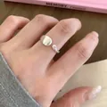 Elegant close-up of a minimalist matte silver open ring featuring a tiny zircon on a finger - Silver Brushed Teardrop Rhinestone Style (JZ5439) / Open Adjustable