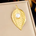 Elegant gold-plated leaf brooch with a large white pearl accent on a jewelry box display - Pearl Leaf Style (JBSW606)