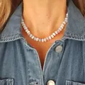 Close-up of candy-colored natural stone abacus bead necklace on a denim jacket. - Knot Necklace / One Size / 43cm / Brown