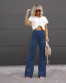 High-waisted blue corduroy flared pants with button closure in a stylish outdoor setting. - Blue