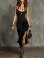 Model walking in black ribbed halter top and slit printed skirt with cowboy boots. - Black