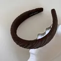 Detailed macro shot of a brown ruched fabric sponge headband with handmade label inside - Twill Pleated Headband / Brown