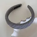 Close-up of a grey pleated sponge headband showing 'HAND MADE' interior label detail. - Twill Pleated Headband / Gray