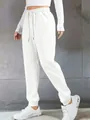 Side view of women's white drawstring sweatpants with ribbed cuffs for casual wear - 3XL / Bottoms / White
